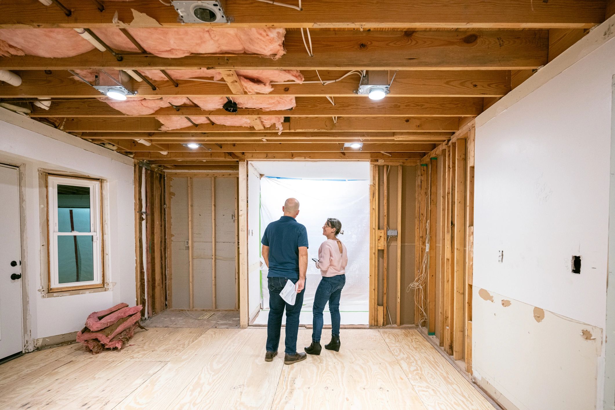 Homeowners reviewing renovation progress inside a property